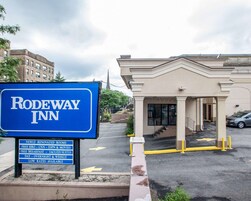 Placa do Rodeway Inn com comodidades incluindo quartos renovados, café da manhã grátis e tarifas baixas.