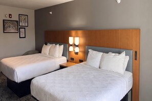 A hotel room with two beds, a wooden headboard, and wall-mounted lights. - Country Inn & Suites by Radisson, Lima (Lima)