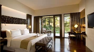 A spacious hotel room with a large bed, a desk, and a television.