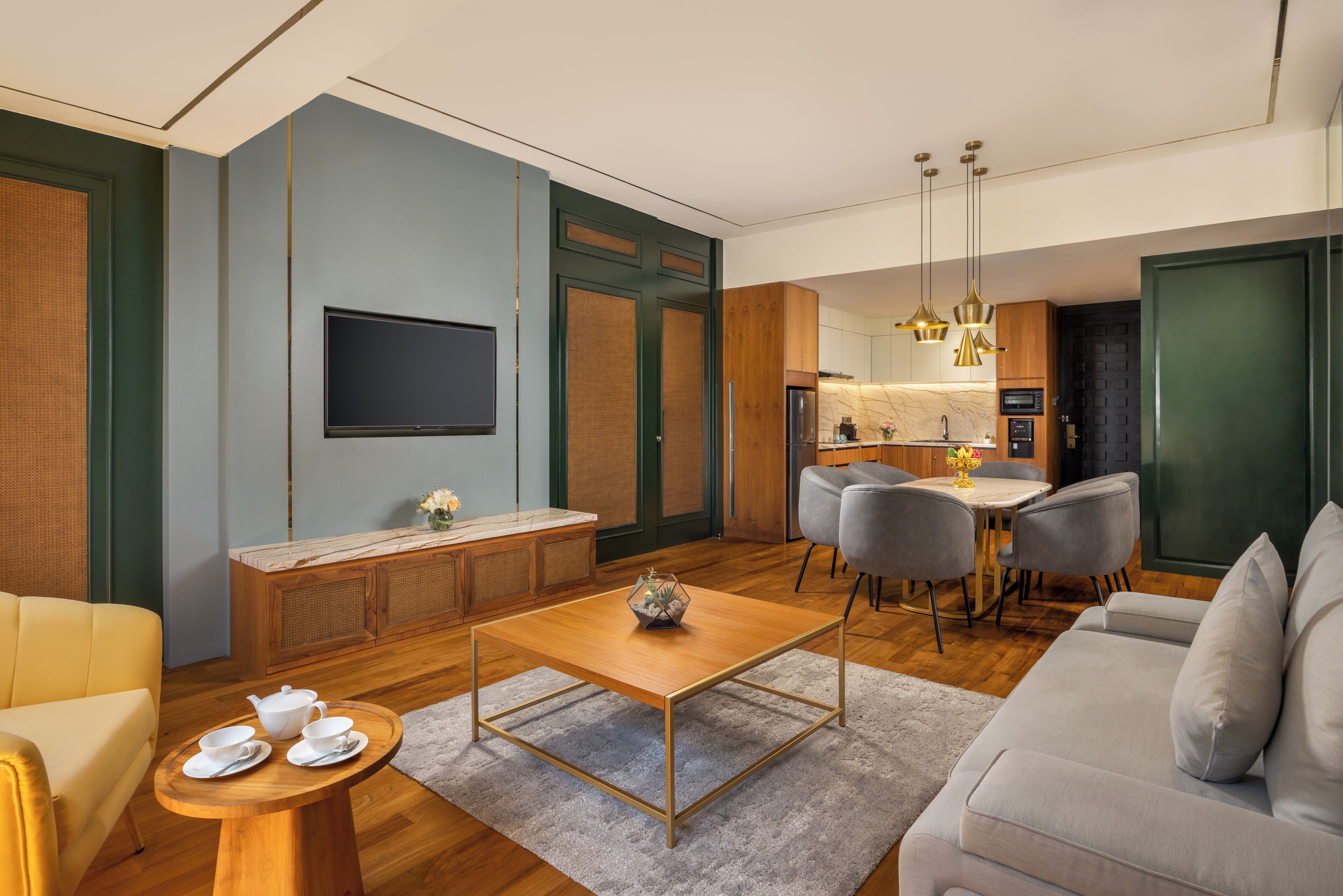 A modern living room with a sofa, a coffee table, and a dining area with chairs.