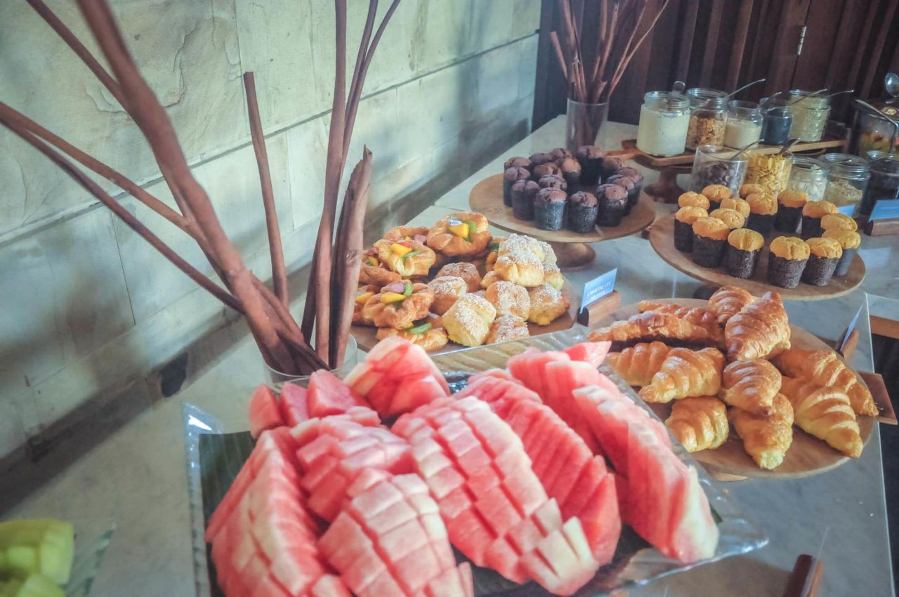 A buffet with various pastries and desserts.