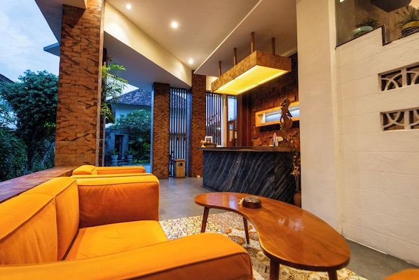 Un interior moderno con una zona de estar, un bar y vistas al exterior.