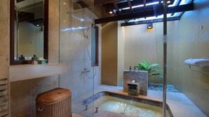 A modern bathroom with a glass-enclosed shower, a small hot tub, and a built-in sink. - AlamKulKul Boutique Resort Kuta Bali (Legian)