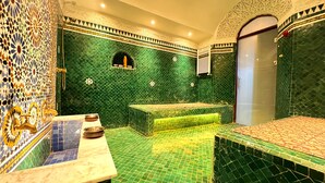 A bathroom with green mosaic tiles, a bathtub, and a sink with two bowls. - Riad Damia Suite &Spa (Fes)