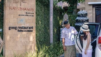 A sign for 'Kayumanis' with a 'gong restaurant' and 'Balinese cuisine' label.