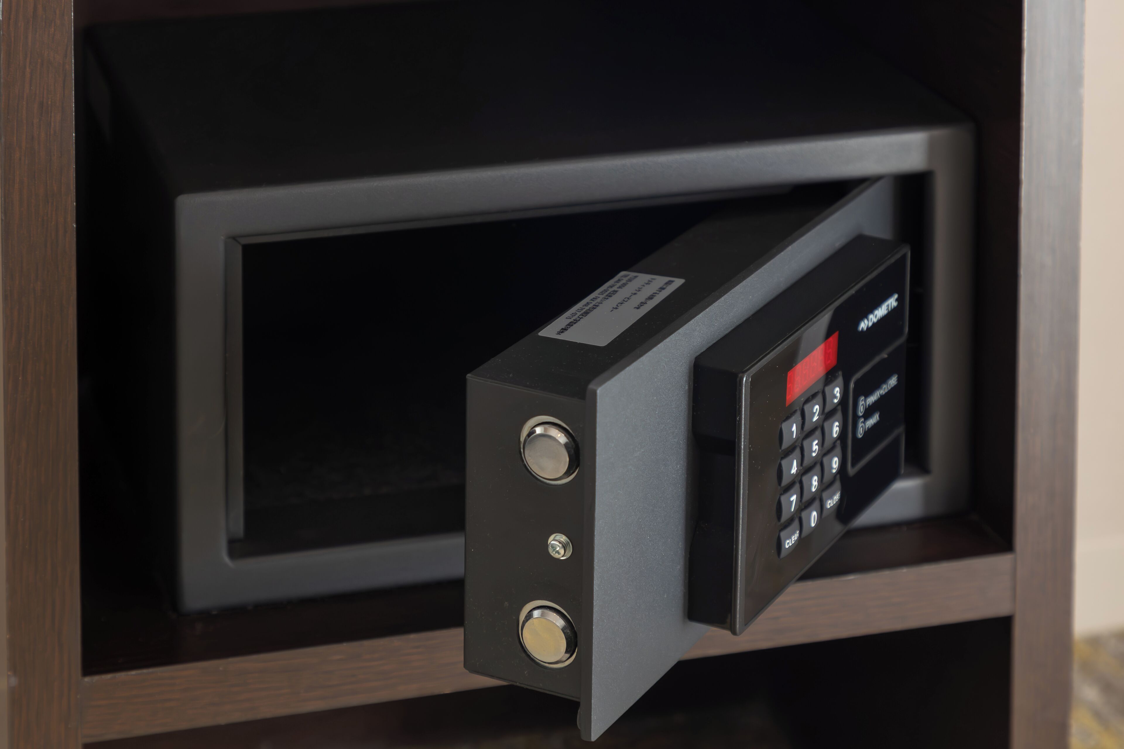 A microwave with a digital keypad and two control knobs.