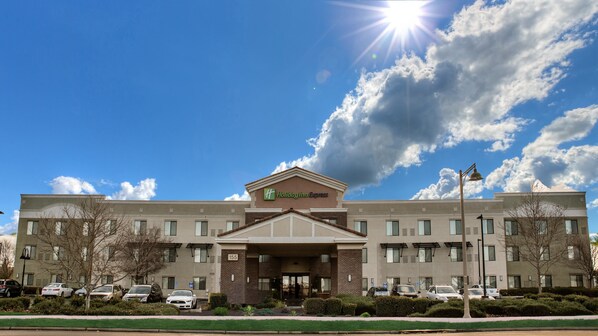 A Holiday Inn Express building with a symmetrical facade, multiple windows, and a central entrance. - Holiday Inn Express Hotel & Suites Lincoln by IHG (Lincoln)