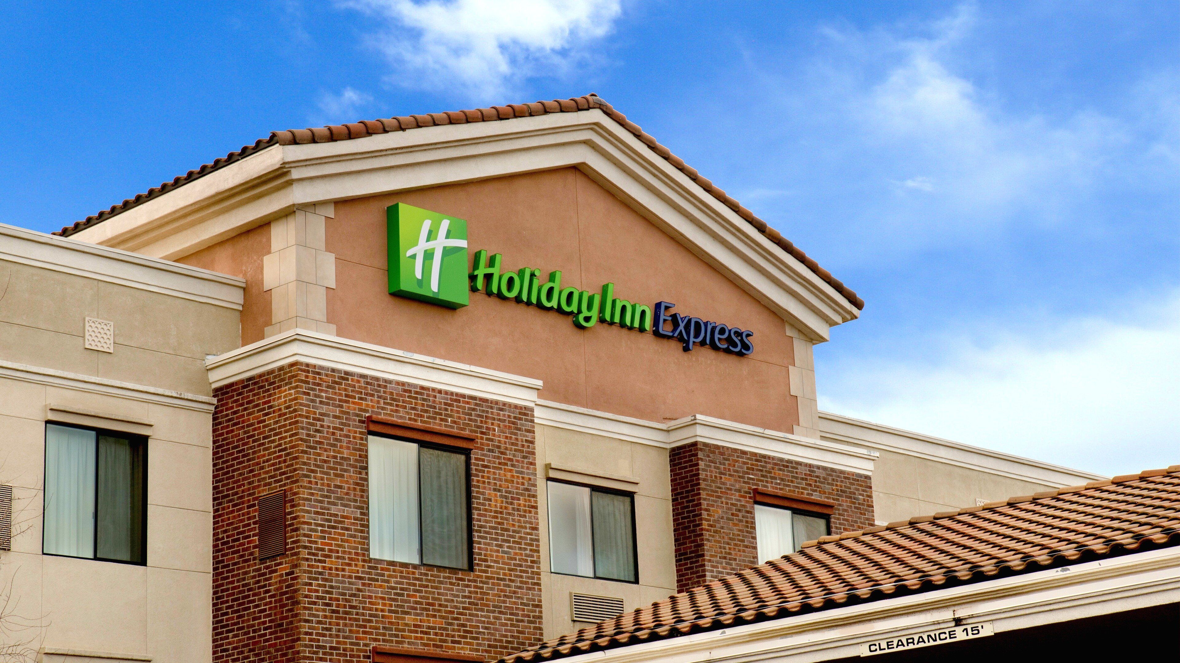 A Holiday Inn Express building with a clear blue sky in the background.