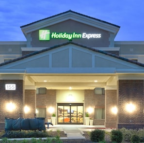 A Holiday Inn Express building with a brick facade, a flat roof, and a large entrance with glass doors. - Holiday Inn Express Hotel & Suites Lincoln by IHG (Lincoln)