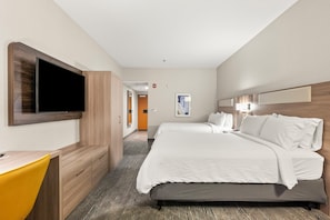 A hotel room with a bed, a desk, a TV, and a door leading to a hallway. - Holiday Inn Express Hotel & Suites Lincoln by IHG (Lincoln)