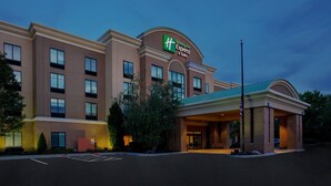 A Holiday Inn Express hotel with a brick facade, multiple windows, and a covered entrance. - Holiday Inn Express & Suites Rochester Webster by IHG (Webster)
