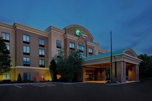 A Holiday Inn Express hotel with a brick facade, multiple windows, and a covered entrance.