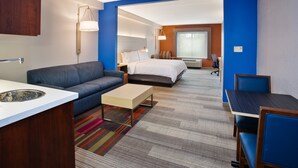 A modern hotel room with a sofa, a bed, a desk, and a chair. - Holiday Inn Express & Suites Rochester Webster by IHG (Webster)
