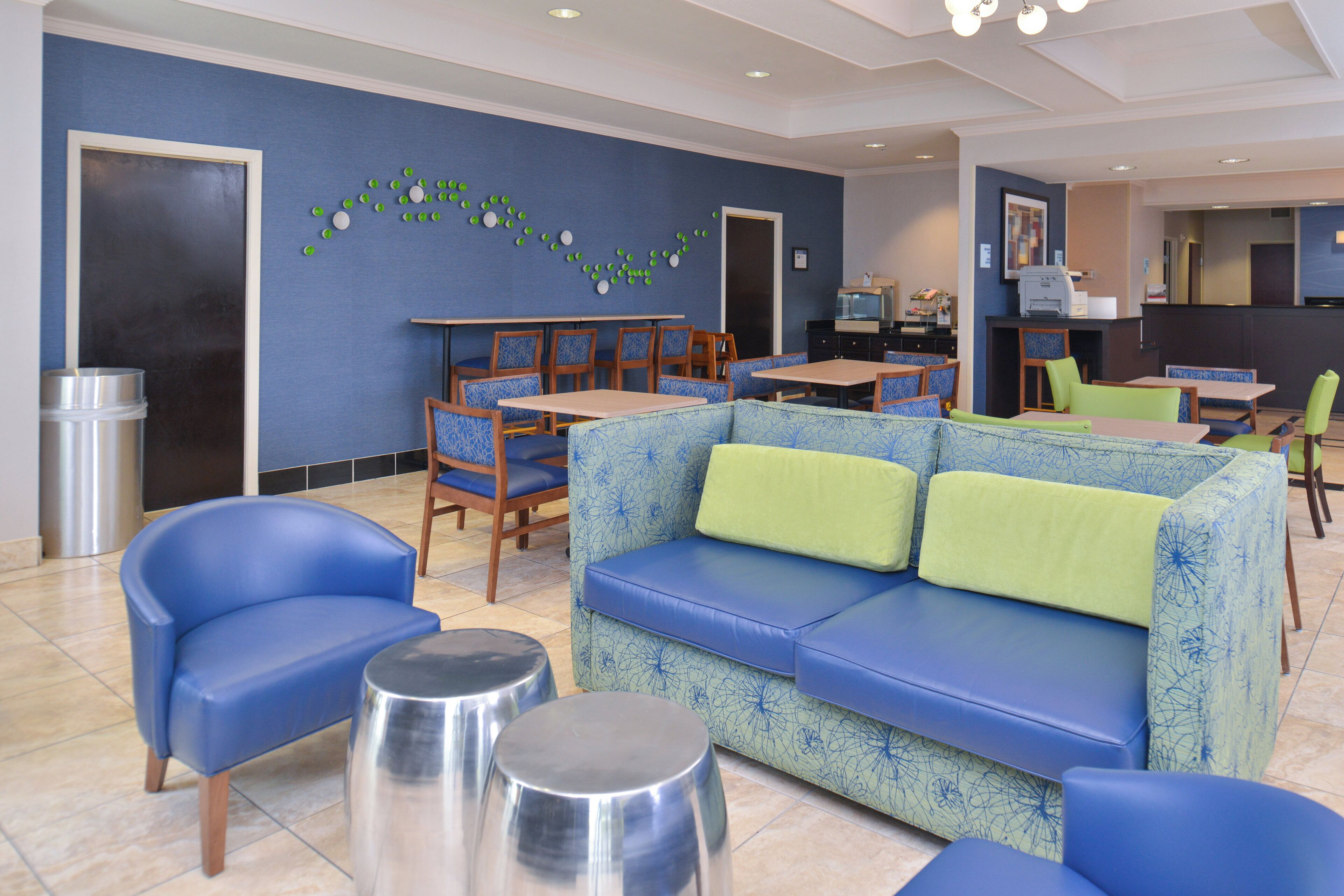 A modern lounge area with a sofa, chairs, and a dining table.