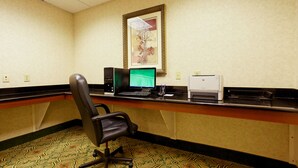 A hotel room with a desk, computer, printer, and a framed picture on the wall. - Holiday Inn Express Hotel & Suites San Antonio by IHG (San Antonio)