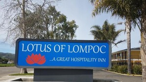 A sign for the Lotus of Lompoc, a great hospitality inn, with a lotus flower emblem. - Lotus of Lompoc - A Great Hospitality Inn (Lompoc)