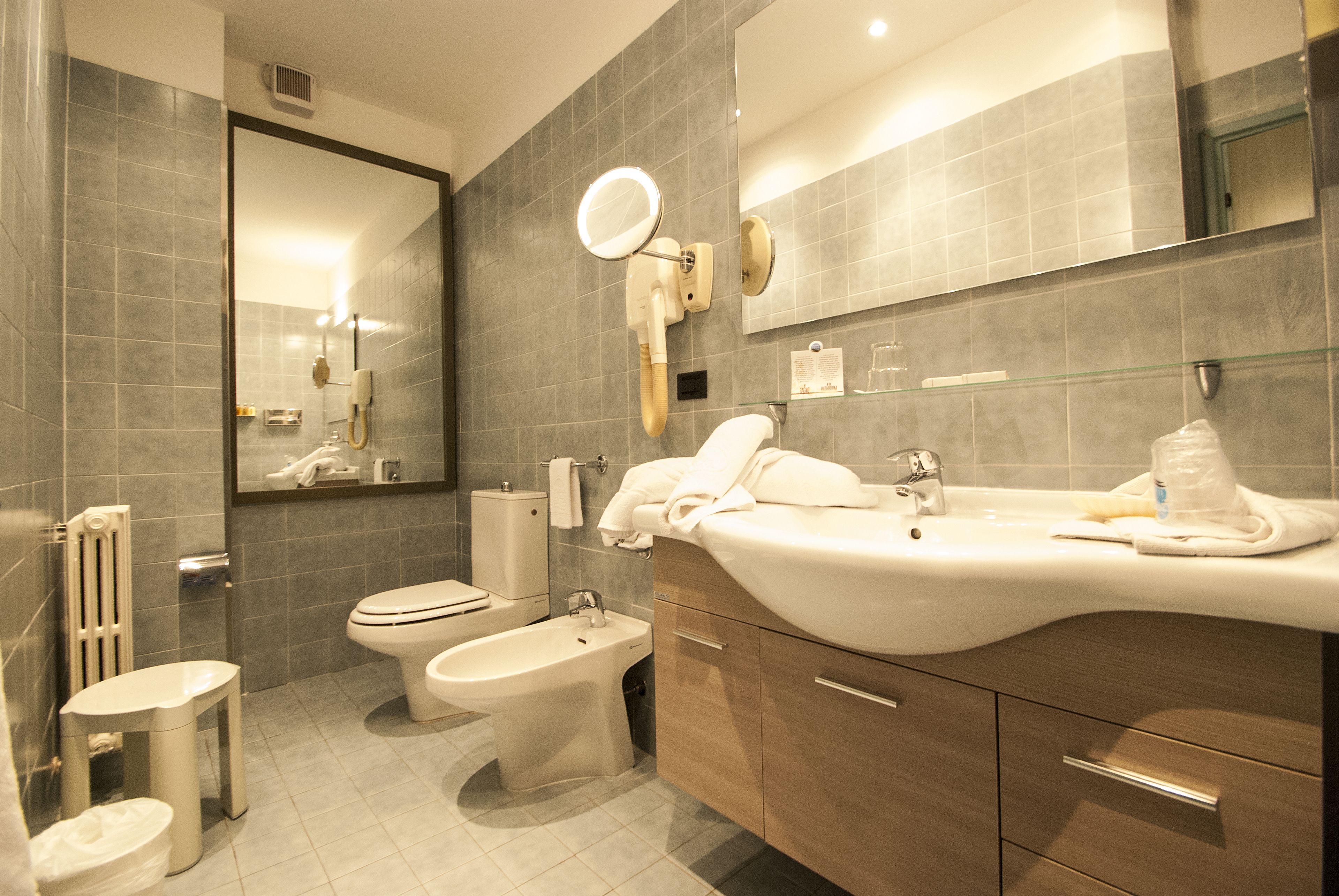 hair dryer, slippers, bidet, towels