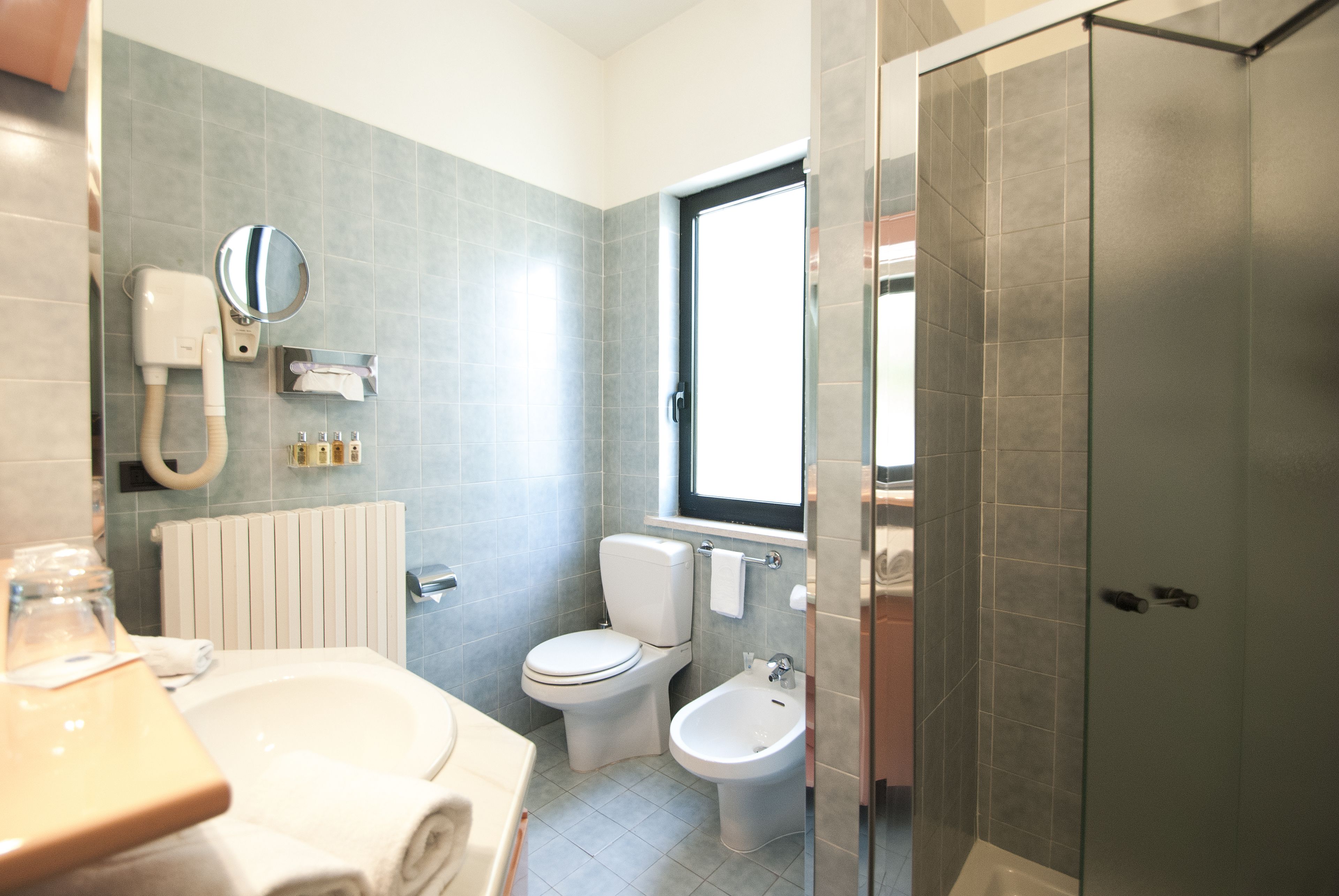 hair dryer, slippers, bidet, towels