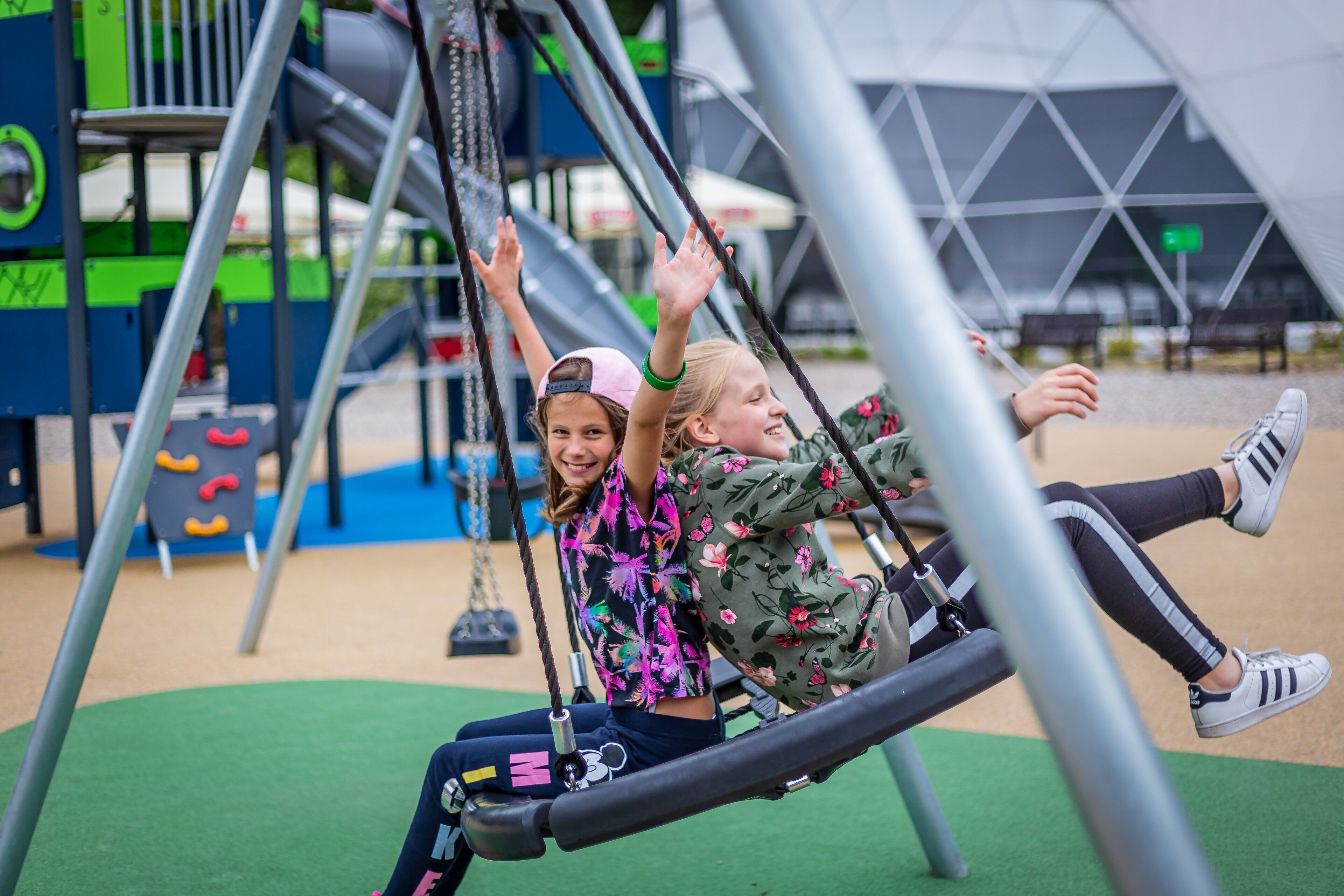 A playground with swings and climbing structures.