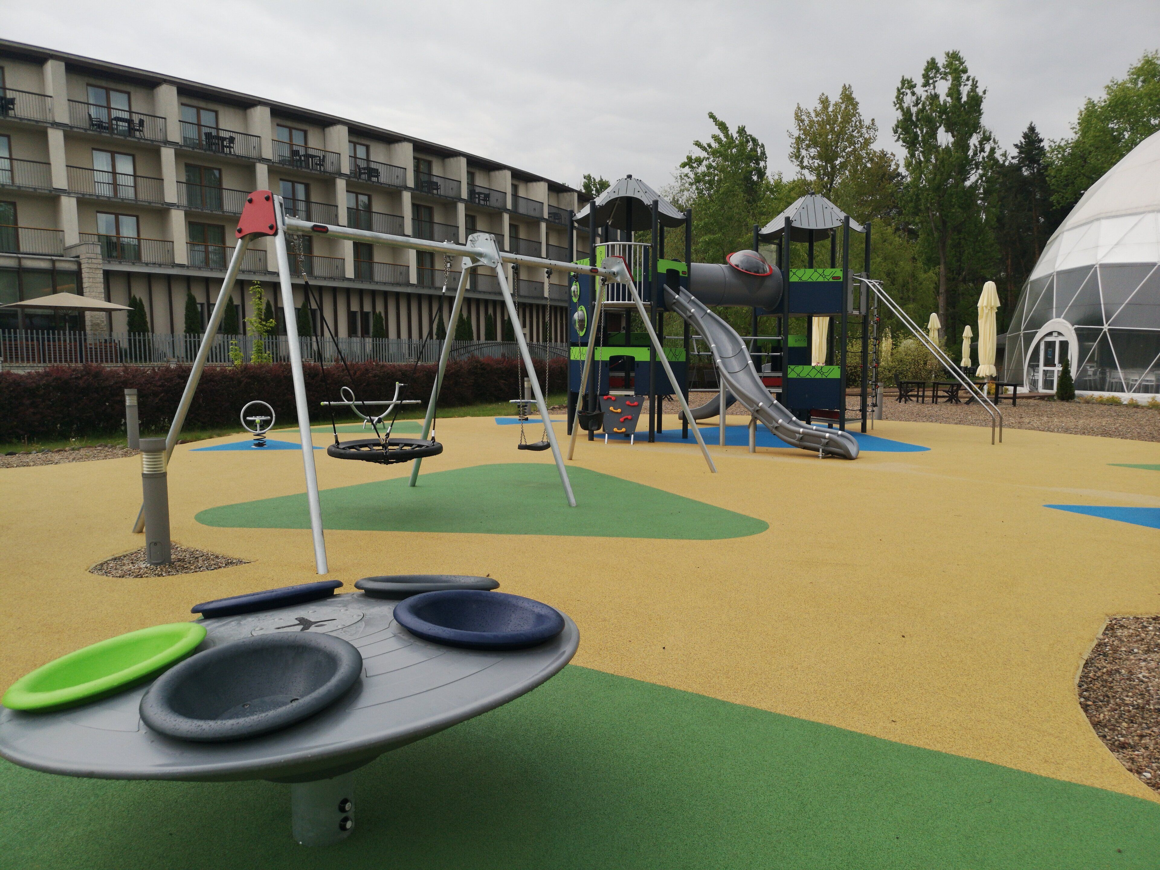 A playground with swings, slides, and a climbing structure.