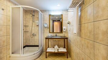 A bathroom with a shower, sink, and mirror.