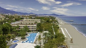 A resort with a large swimming pool, beach, and a pier extending into the sea. - LABRANDA Alantur Resort - All Inclusive (Alanya)