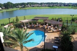 Una piscina al aire libre, sillones reclinables de piscina