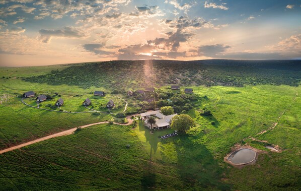 An aerial view of a rural property with multiple houses, a central building, and a pond. - Gorah Elephant Camp (Addo)