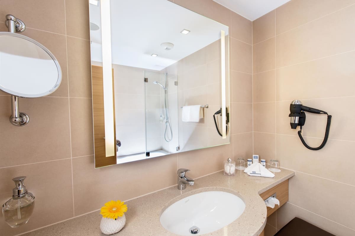 designer toiletries, hair dryer, bathrobes, slippers