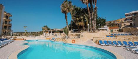 Seasonal outdoor pool, open 9:00 AM to 7:00 PM, pool umbrellas