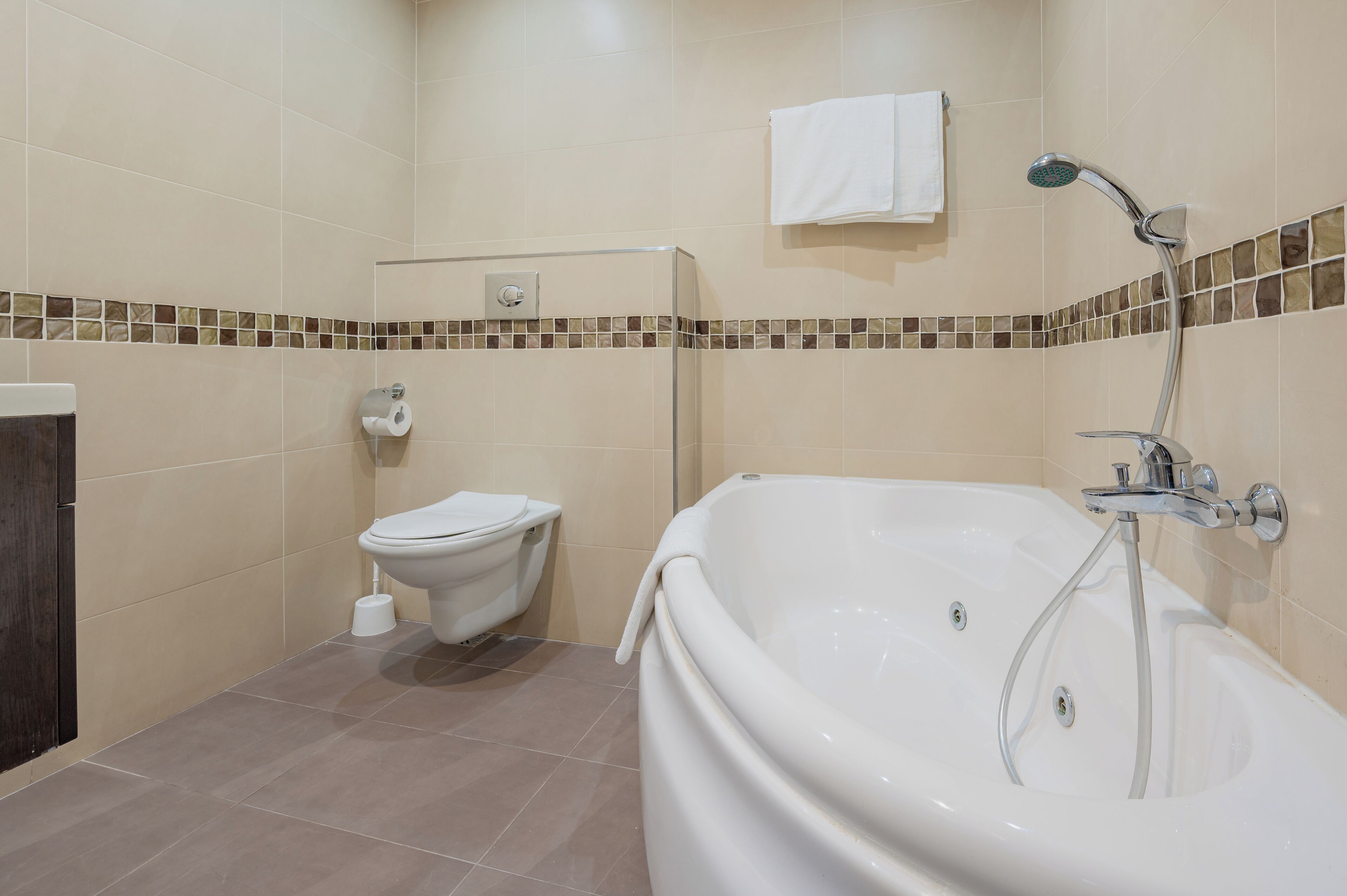 A bathroom with a bathtub, toilet, and shower.