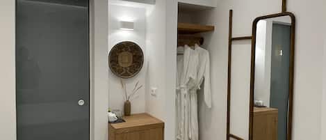 A modern bathroom with a shower, a vanity, and a mirror.