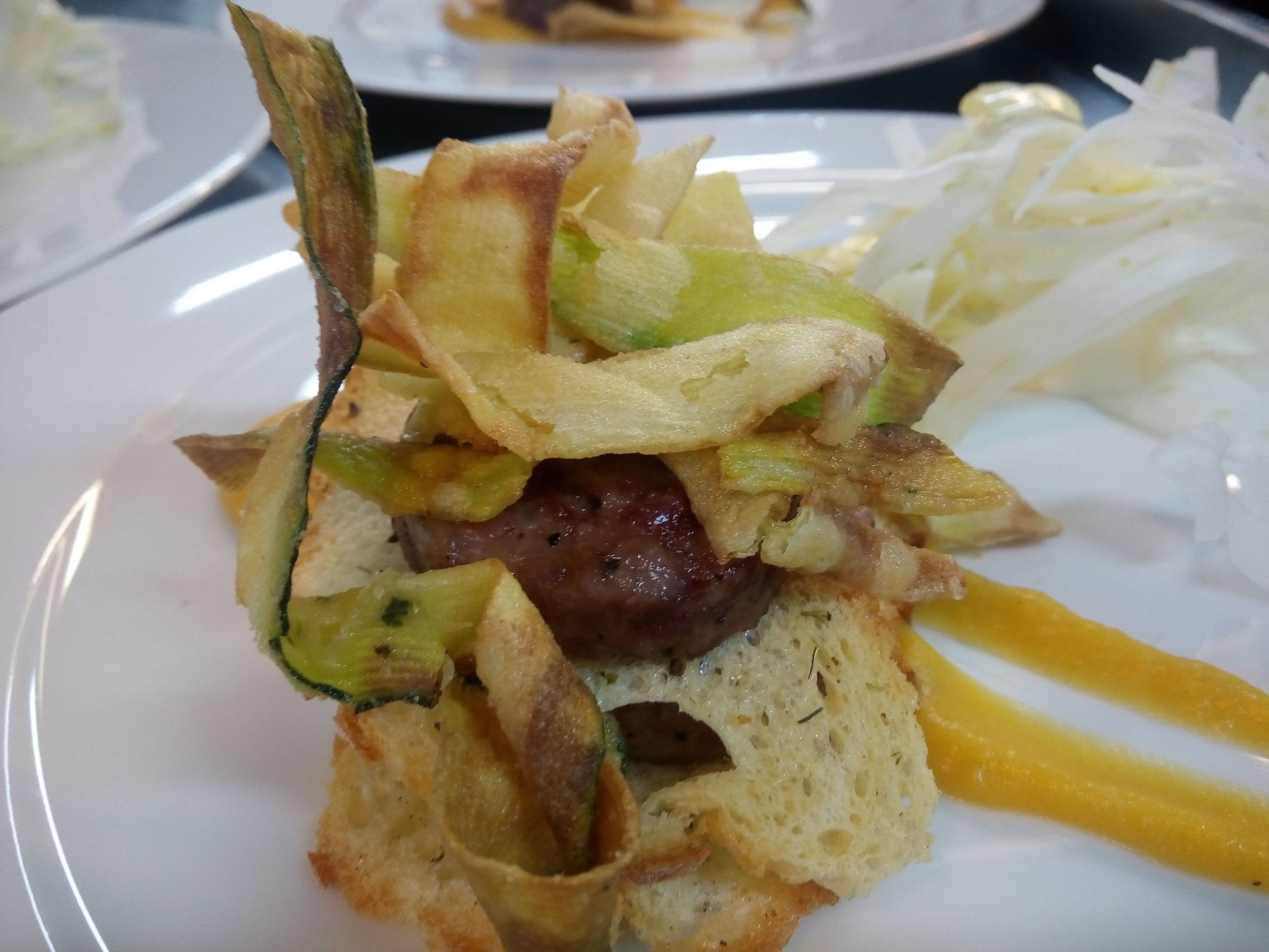 A plate with a meat dish, vegetables, and bread.