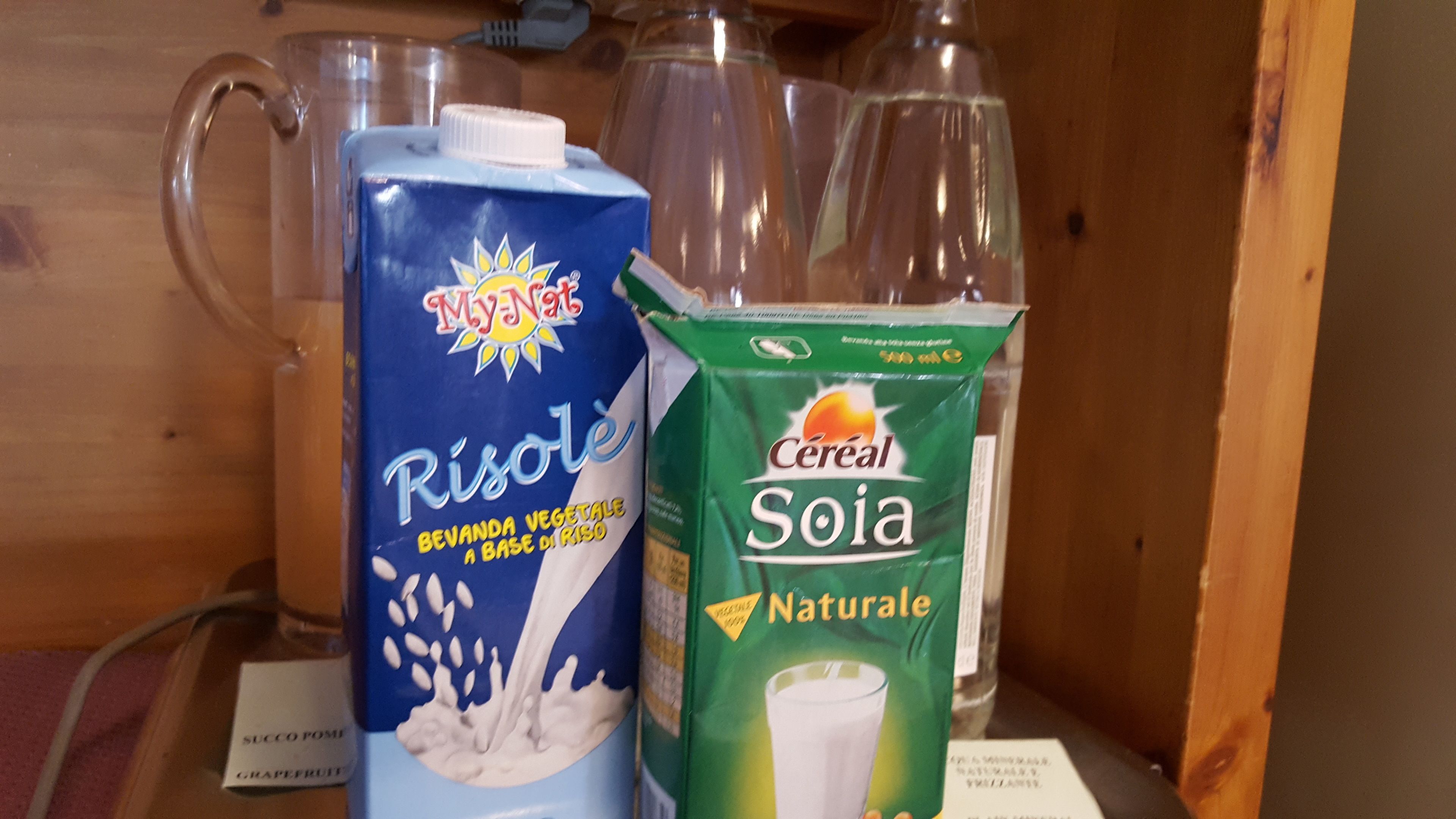 A shelf with a carton of RisoLé and a carton of Cereal Sola.