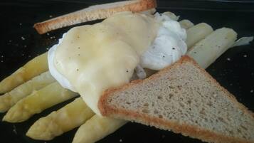 A plate with French fries, a slice of toast, and a poached egg with hollandaise sauce.