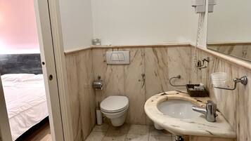 Un baño con inodoro, lavabo y espejo.
