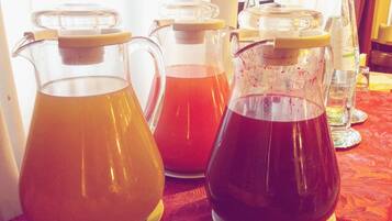 Una mesa con varios jarrones de vidrio que contienen líquidos de diferentes colores, probablemente para servir bebidas.