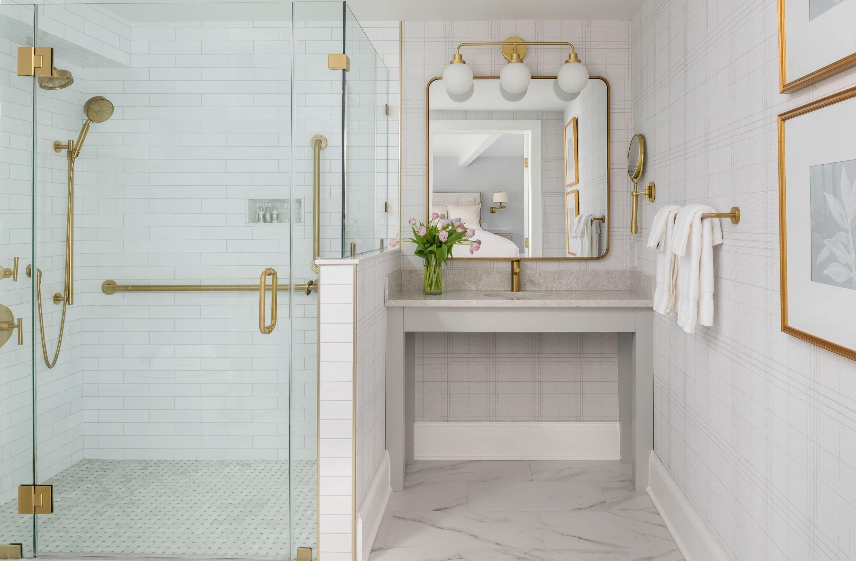 A modern bathroom with a glass-enclosed shower, a vanity with a mirror, and a bathtub.
