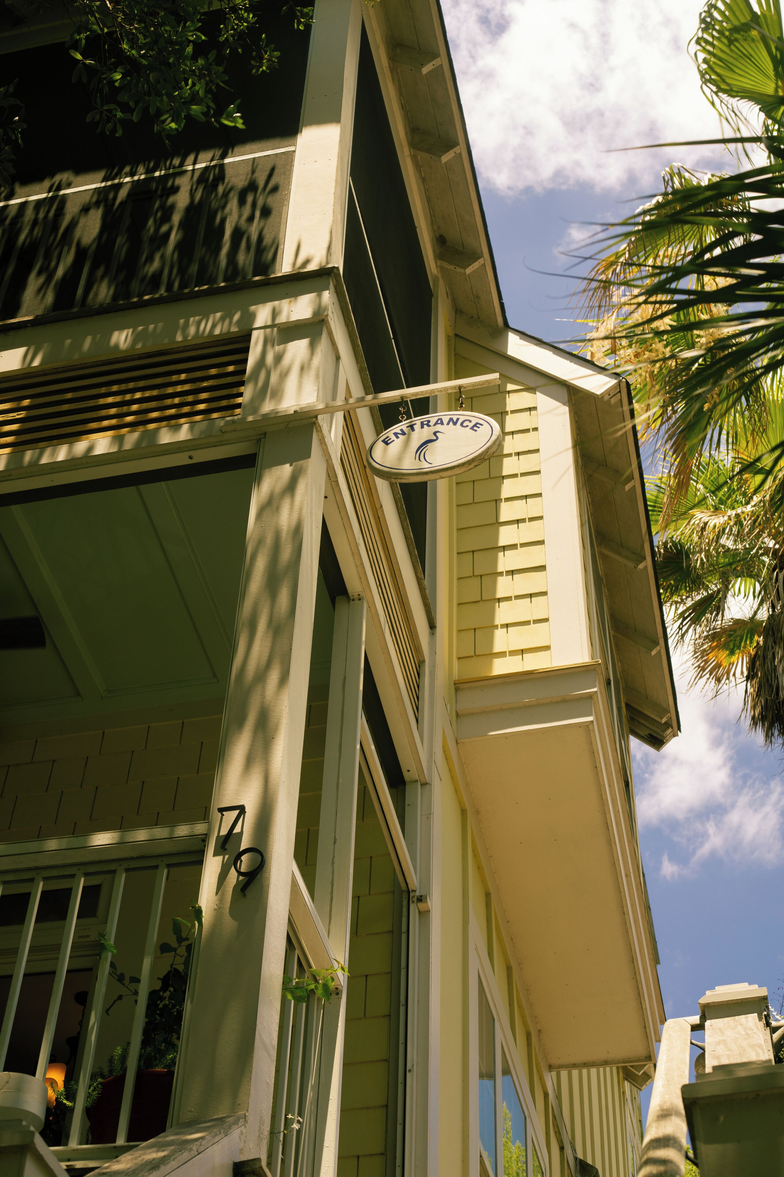 A building with a sign reading 'ENTRANCE' and a number '79' on the facade.