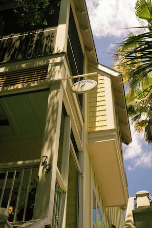 A building with a sign reading 'ENTRANCE' and a number '79' on the facade.