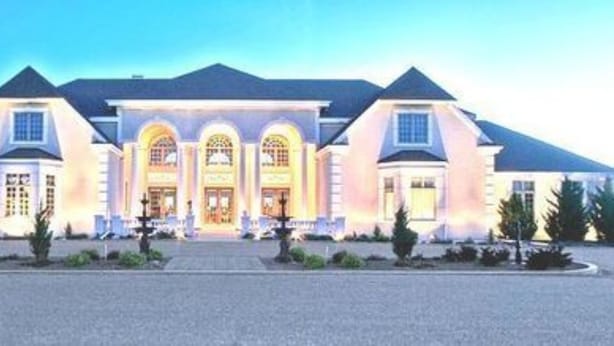 A large, two-story building with a symmetrical facade, multiple arched windows, and a central entrance with a decorative canopy. - Claremont Inn & Winery (Stratton)