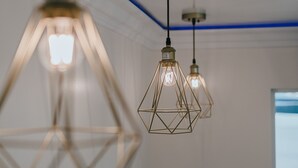Een moderne badkamer met een wit wastafel, een kraan en een raam met uitzicht.