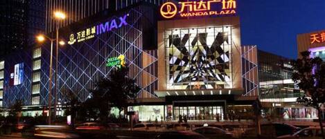 A multi-story building with signage for Wanda Plaza and MAX.