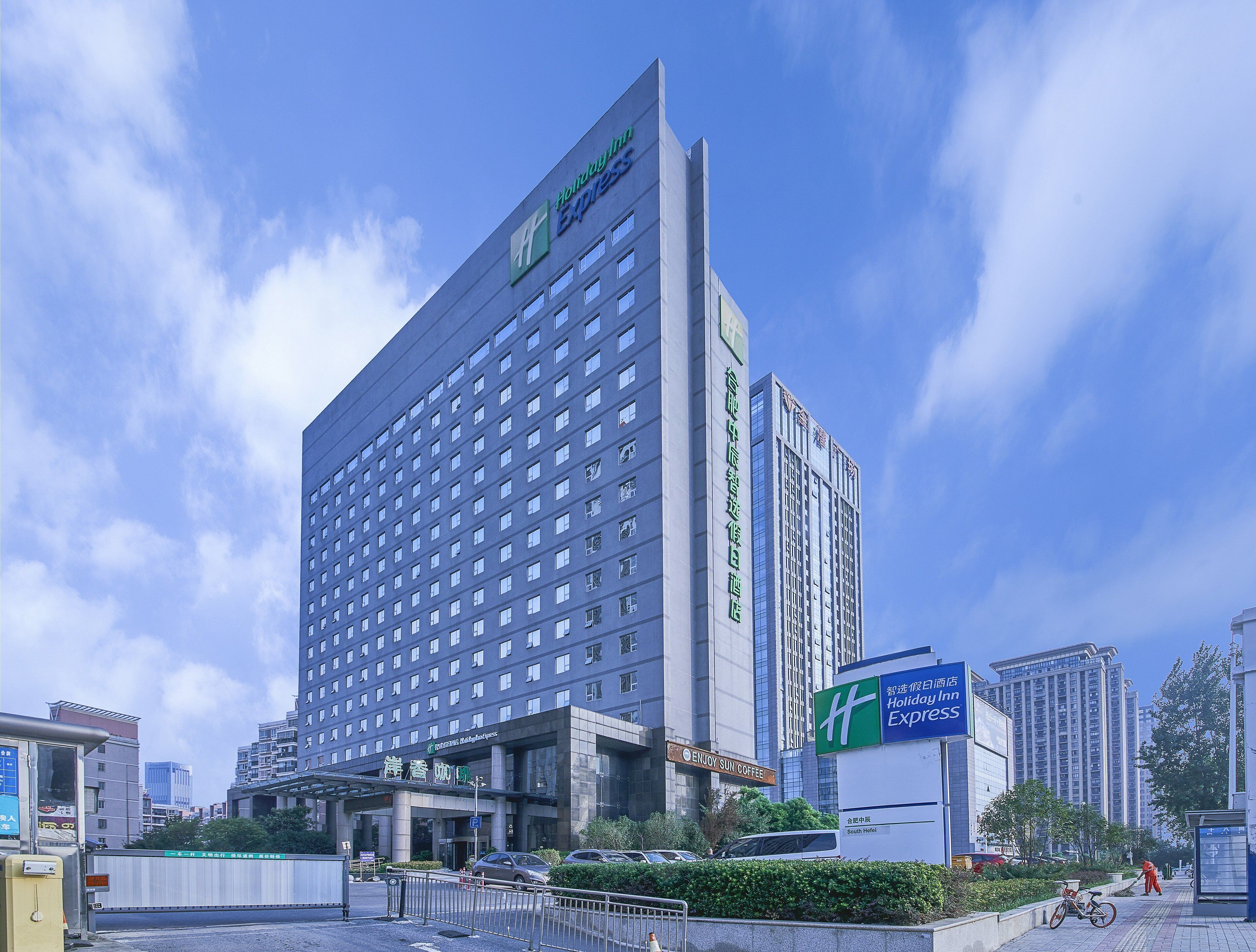 A Holiday Inn Express hotel with a modern design, featuring a prominent 'Holiday Inn Express' sign at the top.