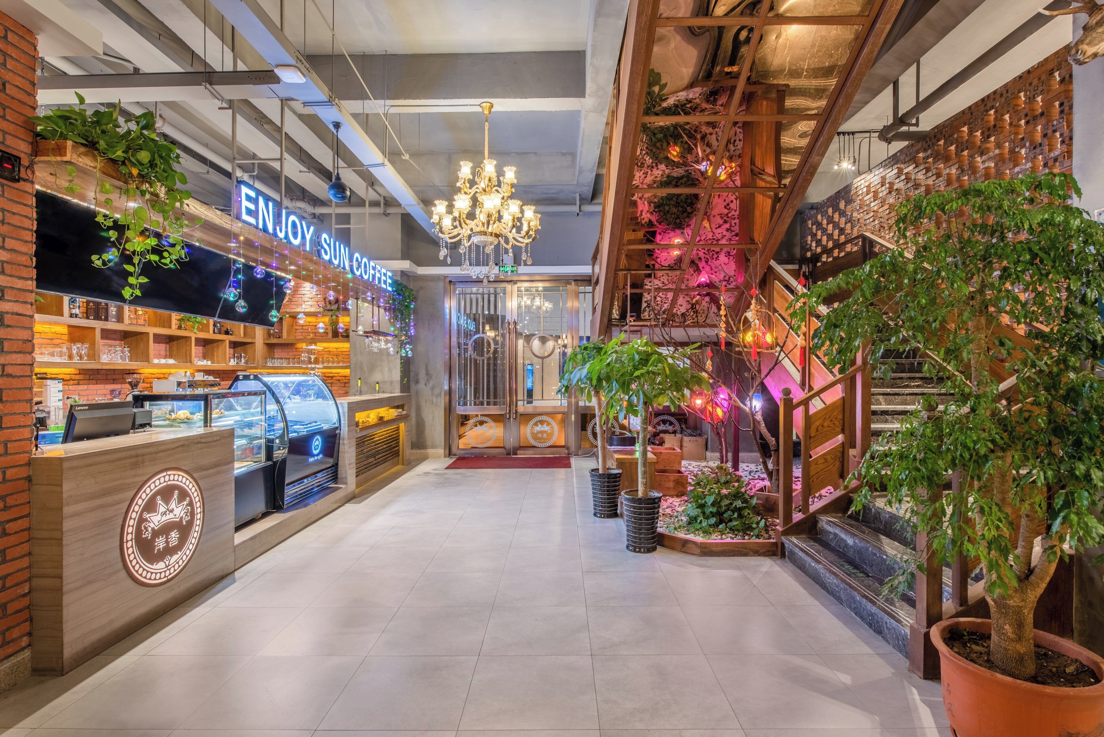 Un café avec une enseigne au néon, une machine à café et un escalier orné de plantes.