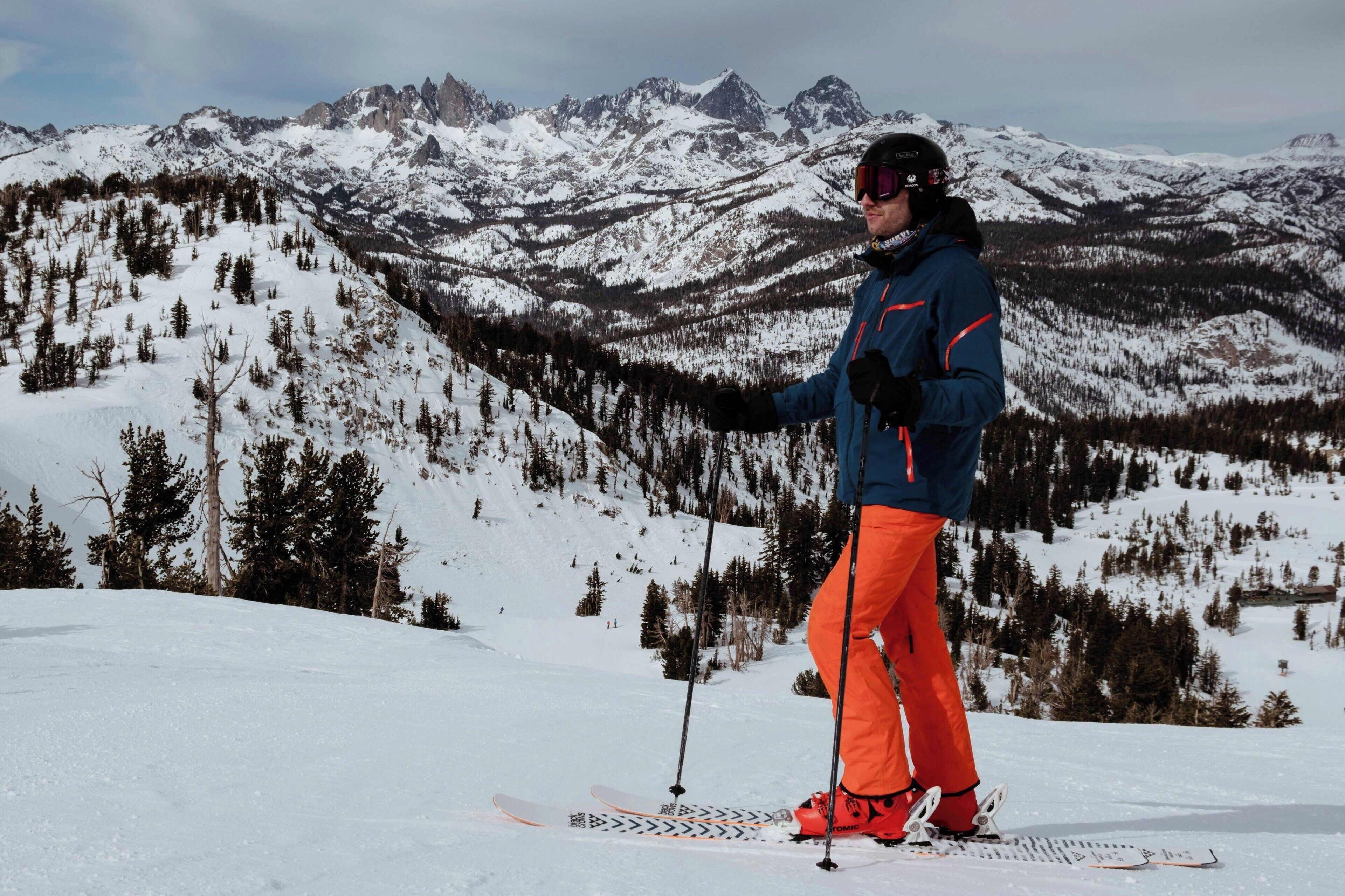A person skiing on a snowy mountain with a clear view of the surrounding peaks.