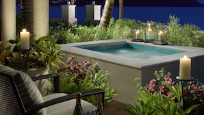 A poolside area with a view of the water and mountains, surrounded by palm trees and plants. - The Landings Resort & Spa (Gros Islet)