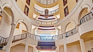 A grand lobby with a high ceiling, multiple balconies, and a grand piano. - The Landings Resort & Spa (Gros Islet)