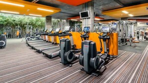 A gym with multiple treadmills, weight machines, and a TV screen. - The Sebel Kiama (Kiama)