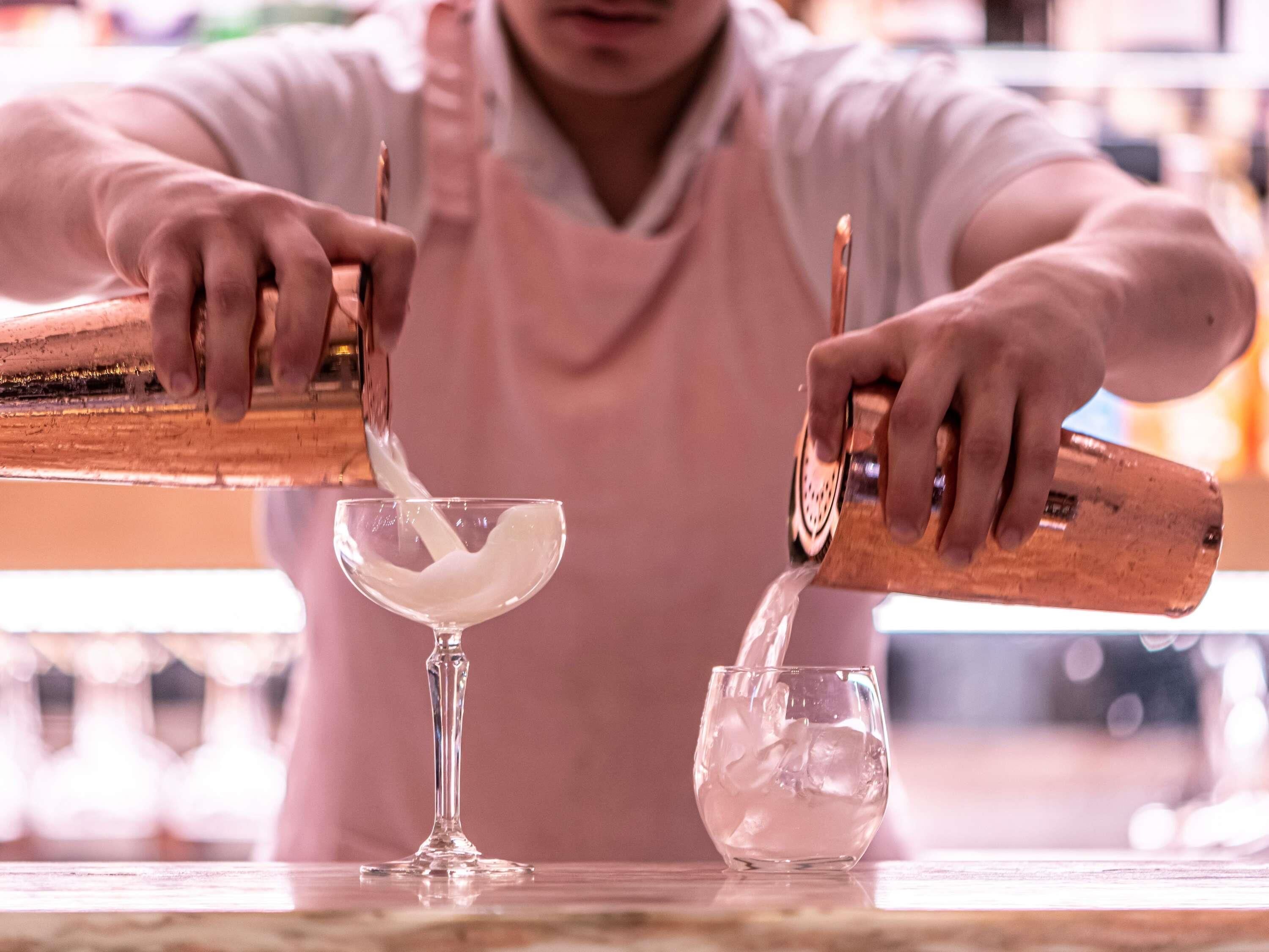 A person pouring liquid into a glass.